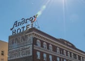Thumbnail 5 of 29 - A photo of the side of The Androy Apartments in Hibbing, MN under a clear, sunny sky