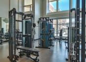 Thumbnail 63 of 75 - indoor gym with free weights, benches, and cable machines at The Apex at CityPlace, Overland Park