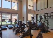 Thumbnail 65 of 75 - gym with rows of treadmills, ellipticals, and exercise bike at The Apex at CityPlace, Kansas