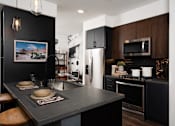 Thumbnail 26 of 53 - Kitchen with stainless steel appliances at Vida North Park, San Diego, 92104