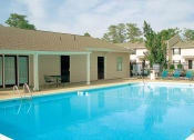 Thumbnail 3 of 18 - pool and lounge chairs behind leasing center at Autumn Chase
