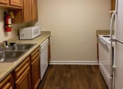 Thumbnail 7 of 18 - kitchen with white appliances and hardwood-style floors