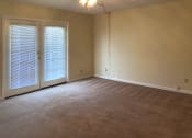 Thumbnail 9 of 18 - large living room with ceiling fan and french doors to deck