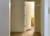 Thumbnail 12 of 18 - closet area with doorway to bathroom