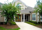 Thumbnail 2 of 13 - leasing office and clubhouse exterior with crepe myrtles