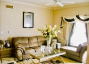 Thumbnail 10 of 13 - a living room with model furnishings and a ceiling fan