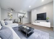 Thumbnail 1 of 18 - a living room with a couch and a table