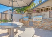 Thumbnail 5 of 22 - a patio with a table and chairs and a barbecue grill
