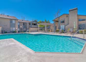 Thumbnail 11 of 22 - a swimming pool with apartments in the background