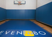 Thumbnail 15 of 38 - Indoor basketball court with property logo on floor
