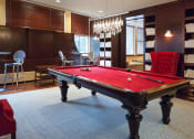 Thumbnail 23 of 38 - Newark Apartments for Rent-Eleven80 Apartments Game Room With Seating And Billiards Table