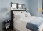 Thumbnail 6 of 38 - Apartments for Rent in Newark-Eleven80 Apartments Carpeted Bedroom With Modern Decor And Window With City View