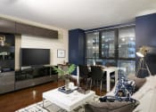 Thumbnail 8 of 33 - Living Room with modern entertainment console at Wilshire Vermont, Los Angeles