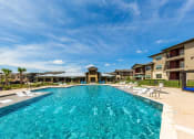 Thumbnail 27 of 39 - Stunning Pool Area with Tables, Lounge Chairs and BBQ Area at Legacy Creekside Apartments, San Antonio, 78251
