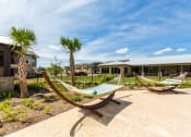 Thumbnail 28 of 39 - Hammocks in the Pool Area at Legacy Creekside Apartments, Texas