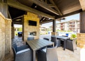 Thumbnail 29 of 39 - Lounge Area with Fireplace and BBQ Area at Legacy Creekside Apartments, San Antonio, Texas