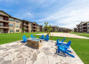 Thumbnail 31 of 39 - Fire Pit with Chairs at Legacy Creekside Apartments, Texas