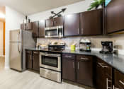 Thumbnail 18 of 39 - Stainless Steel Appliances & Stove & Microwave at Legacy Creekside Apartments, San Antonio, 78251