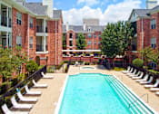 Thumbnail 23 of 50 - Luxury apartments with large swimming pool, multiple swimming pools, spa, and large sundeck with poolside lounge chairs at The Lanesborough Apartments in Houston