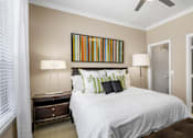 Thumbnail 15 of 50 - Spacious master bedroom with attached master bathroom and walk-in closet, ceiling fan and 9-foot ceilings at The Lanesborough Apartments in Houston.