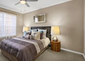 Thumbnail 7 of 50 - Spacious bedroom with walk-in closet and ceiling fan at The Lanesborough Apartments in Houston.