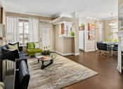 Thumbnail 1 of 50 - Spacious living room and dining room with wood-burning fireplace with glass doors, ceiling fan, 9-foot ceilings and wood grain plank flooring at The Lanesborough Apartments in Houston.