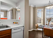 Thumbnail 43 of 50 - Spacious dining room with 9-foot ceilings, oversized windows, French door and wood grain plank flooring and kitchen with recessed ceiling at The Lanesborough Apartments in Houston.