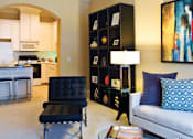 Thumbnail 6 of 28 - Spacious living room and bright kitchen with white cabinets at Tuscany Court Apartments in Houston.