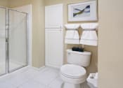 Thumbnail 24 of 38 - Luxury bathroom with tiled floors, glass shower, linen closet, and white cabinets in at TurtleCreek apartments in West Des Moines, Iowa