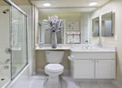 Thumbnail 31 of 38 - Luxury bathroom with tiled floors, oval soaking tub, built-in vanity, cultured marble vanity, glass shower and white cabinets in at TurtleCreek apartments in West Des Moines, Iowa