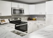 Thumbnail 33 of 37 - The Fletcher Model Apartment Kitchen at The Fletcher Southlands, Aurora, 80015