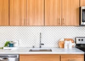 Thumbnail 12 of 36 - Tile backsplash and walnut finish cabinets