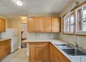 Thumbnail 6 of 25 - a kitchen with wooden cabinets and a sink