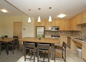 Thumbnail 5 of 26 - A kitchen with a dining table and chairs.