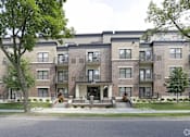 Thumbnail 26 of 26 - Apartment buildings with trees in front of them.