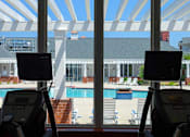 Thumbnail 6 of 29 - fitness center has a view of the pool at 1200 Acqua Luxury Apartments in Petersburg