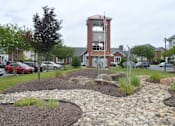 Thumbnail 18 of 29 - beautifully landscaped entrance to 1200 Acqua Luxury Lifestyle Apartments in Petersburg Virginia near Fort Lee