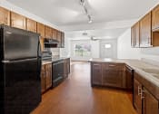 Thumbnail 3 of 31 - A large kitchen with efficient appliances, ample cabinetry, and natural light at Muskego School Apartments