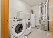 Thumbnail 23 of 31 - a washer, dryer, hot water heater, and HVAC in a home at Muskego School Apartments