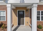 Thumbnail 2 of 31 - Individual portico entrances at Muskego School Apartments for seniors in Muskego, WI