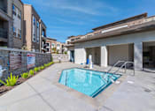 Thumbnail 12 of 33 - A small pool in a patio of a building.