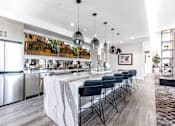 Thumbnail 18 of 33 - A modern kitchen with a long island and stainless steel appliances.