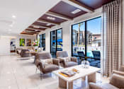 Thumbnail 33 of 33 - A modern living room with a large window and a view of the city.