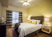 Thumbnail 6 of 22 - Liberty Gateway Apartments, Salt Lake City, Utah, bedroom with a bed, nightstand, and window.