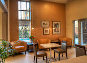 Thumbnail 9 of 22 - Liberty Gateway Apartments, Salt Lake City, Utah, kitchenette with a table and chairs and a vase of flowers on the table.