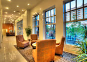 Thumbnail 13 of 22 - Liberty Gateway Apartments, Salt Lake City, Utah, a lounge area with chairs and plants on either side.