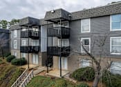 Thumbnail 5 of 13 - Apartment building with a black balcony railing.