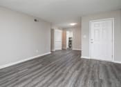 Thumbnail 10 of 13 - A room with a white door and a grey floor.
