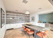 Thumbnail 5 of 73 - A modern kitchen with a dining table and chairs.