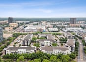 Thumbnail 47 of 48 - A cityscape with a mix of modern and older buildings, surrounded by greenery at Everra Midtown Park Apartments, Texas